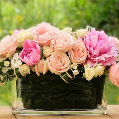 Rectangular flower arrangement for the Yom Tov table with plenty of peonies, roses, and ornithogalum Vase size 10*30 cm, arrangement length approximately 45 cm